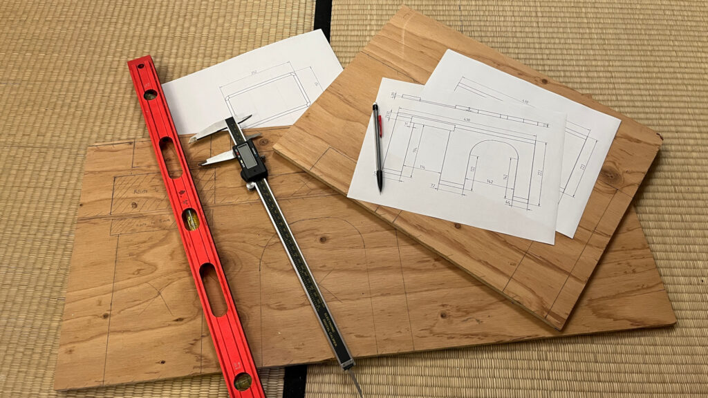 Marked up pieces of wood with paper diagrams on top